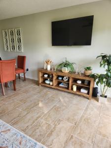 a living room with a flat screen tv on a wall at D&T Flamingo Paradise in Haines City