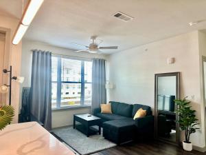 a living room with a couch and a window at Cozy apartment near downtown HTX in Houston