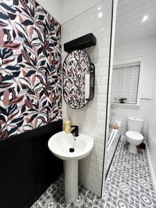 a bathroom with a sink and a toilet at Ground Floor Entire Apartment Self Checkin in Crossgates +35 photos