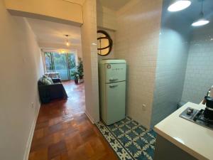 a kitchen with an old refrigerator in a room at Vintage Apartment Lastarria in Santiago