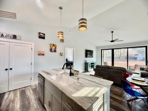 a kitchen with a sink and a living room at HubCityHaven 2 New, 3BR 2BA in Moore