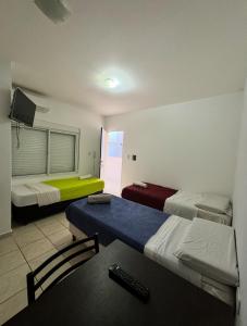a room with two beds and a table and a couch at Terminal 1 in Villa María