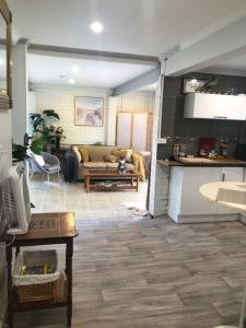 a living room with a couch and a table at Water Street - Garden Views in Forster