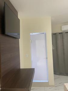 a room with a sliding door and a television at Hotel Patriarca in Sao Paulo +15 photos