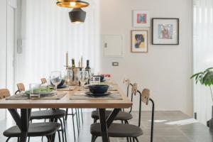 a dining room with a wooden table and chairs at INFINITY HOTEL -Higawa- in Naha