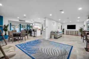 a living room with a table and chairs and a living room at Adventure at Siesta Key Beach & Sandbar Escape in Sarasota