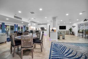 a dining room and living room with a table and chairs at Adventure at Siesta Key Beach & Sandbar Escape in Sarasota