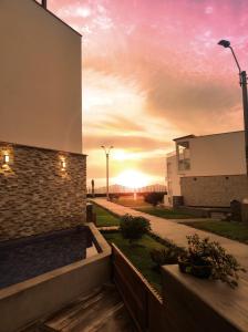 a sunset view from the outside of a building at Casa de playa Bujama, Mala, Asia, Lima, Moravia II in Bujama Baja