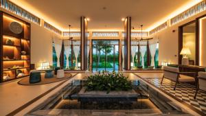 a lobby with a fountain in the middle of a room at Mia Quy Nhon in Quy Nhon