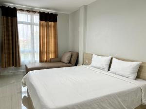 a bedroom with a large white bed and a chair at DD Boutique Resort in Ban Wat Pa +64 photos