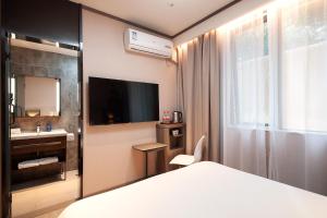 Voodi või voodid majutusasutuse Hanting Hotel Shanghai Lujiazui Pudong South Road toas