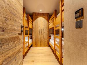 a room with four bunk beds and a wooden door at Appartement 3 chambres à Méribel, service 5* - FR-1-613-138 in Les Allues +3 photos