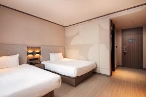 Voodi või voodid majutusasutuse Hanting Hotel Shanghai Lujiazui Pudong South Road toas