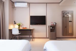 Voodi või voodid majutusasutuse Hanting Hotel Shanghai Lujiazui Pudong South Road toas