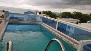 a swimming pool on the balcony of a house at Vamar Apartamentos in San Felipe de Puerto Plata
