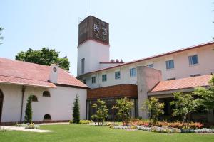 a building with a clock tower on top of it at Senri Hankyu Hotel Osaka in Toyonaka