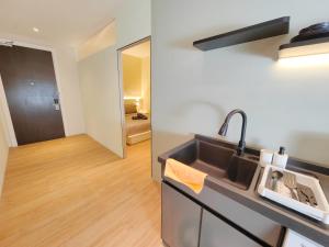 a kitchen with a sink and a mirror at The Tranquil - Bangsar Trade Centre in Kuala Lumpur