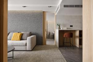 a living room with a couch and a kitchen at JAI Château Hotels & Hostels in Tainan +23 photos