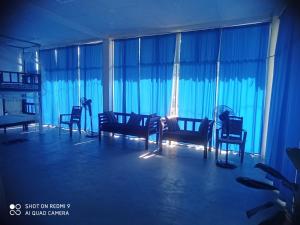 a living room with chairs and a large window at Dream Sun hostel in Weligama