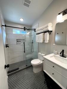 a bathroom with a shower and a toilet and a sink at Redwood Oasis - Private Heated Pool by State Park! in Felton