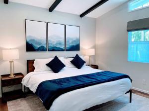 a bedroom with a large bed with three windows at Redwood Oasis - Private Heated Pool by State Park! in Felton +41 photos