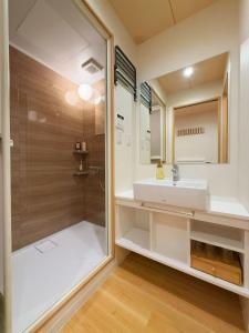 a bathroom with a sink and a shower at M house asakusa kaminarimon tokyo in Tokyo +97 photos