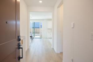 an empty hallway with white walls and wooden floors at Modern Charming 4BR Home, Family Friendly, Office Space, Fast WiFi, Free Parking in Folsom
