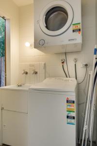a washer and dryer on the wall of a kitchen at Brampton Cottage in Hobart