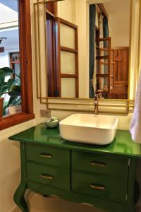 a bathroom with a sink and a mirror at Senora Ines Hotel Boutique in Buga
