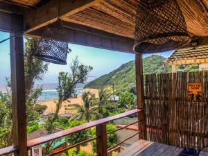 a view of the beach from a balcony of a resort at Bamboo Room in Ponta do Ouro +30 photos