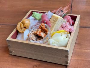 a wooden box filled with different types of food at Ogal Inn in Yahaba +17 photos