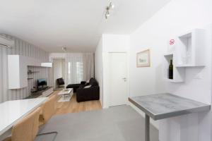 a white living room with a couch and a table at Luxury Apartment "Ema", sea view in Split +21 photos