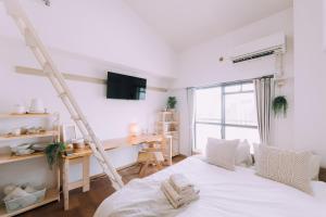 a bedroom with a bed and a ladder and a desk at New! Top 7th floor 702 Japandi loft in Prime Location in Fukuoka
