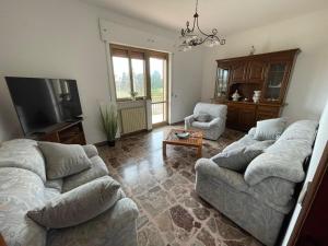 a living room with two couches and a flat screen tv at Villa OLGA in Ginosa Marina