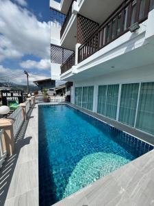 a swimming pool in the middle of a house at MM Hill Koh Samui Hotel - SHA Certified in Chaweng
