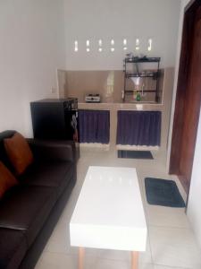 a living room with a couch and a coffee table at LilyPad guest house in Kuta Lombok +33 photos