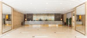 a lobby with a reception desk in a building at Kowloon Harbourfront Hotel in Hong Kong +43 photos