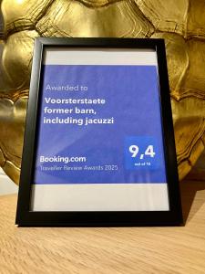 a framed picture on a table in front of a trophy at Voorsterstaete former barn, including jacuzzi in Voorst