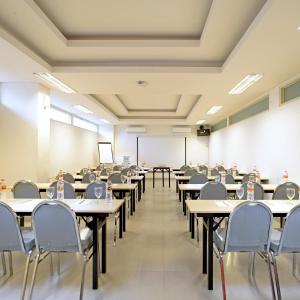 an empty classroom with tables and chairs in it at POP! Hotel Diponegoro in Surabaya