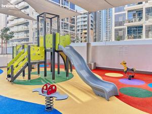 a childrens play area with a slide in a building at bnbmehomes - Azizi Riviera 45 in Dubai