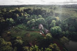 an aerial view of a house on a hill next to a lake at De Lueb Domitory in Ban Houayman