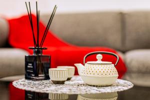 a table with a tea pot and cups on it at J S暁宅-睦月 mutsuki in Osaka