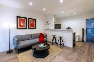 a living room with a couch and a table at J S暁宅-睦月 mutsuki in Osaka