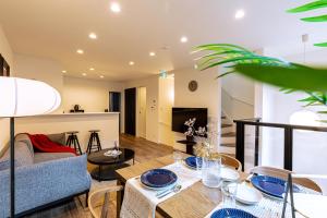 a living room with a table and a couch at J S暁宅-睦月 mutsuki in Osaka +31 photos