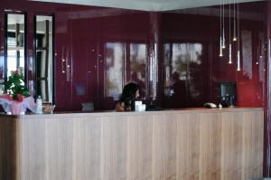 a woman sitting at a counter in a restaurant at Candan Citybeach Hotel in Marmaris
