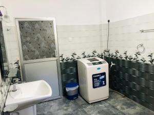 a bathroom with a sink and a toilet and a dispenser at Wakishta Villa - Weligama in Weligama +26 photos
