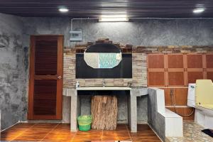 a kitchen with a counter with a tv on a wall at Tung Lakorn Farm in Ban Mae Ta Man (1)