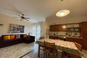 a living room with a table and a couch at La Pietra sul Mare - Happy Rentals in Pietra Ligure