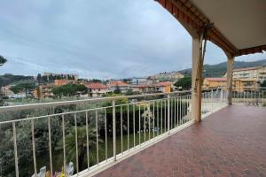 a balcony with a view of a city at La Pietra sul Mare - Happy Rentals in Pietra Ligure