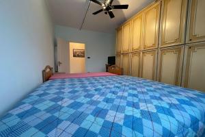 a bedroom with a bed with a blue at La Pietra sul Mare - Happy Rentals in Pietra Ligure
